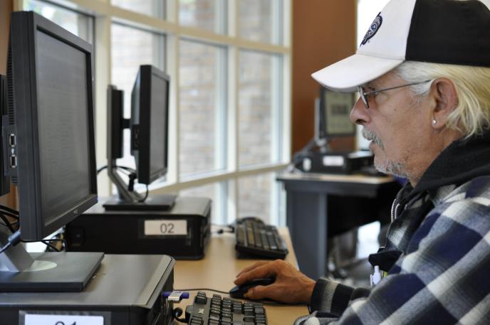 Man using computer at Charlotte Mecklenburg Library's Job Help Center. Man using computer at Charlotte Mecklenburg Library's Job Help Center.