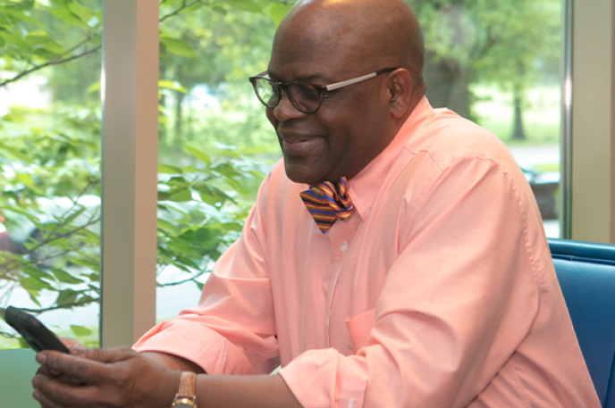Man reading on his mobile device at Charlotte Mecklenburg Library. Man reading on his mobile device at Charlotte Mecklenburg Library.