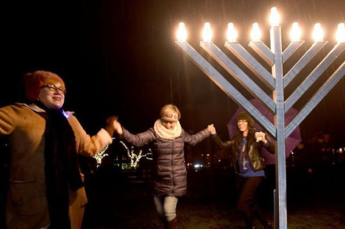 Photo of people dancing around a Hanukkah menorah courtesy of the Chicago Tribune Photo of people dancing around a Hanukkah menorah courtesy of the Chicago Tribune