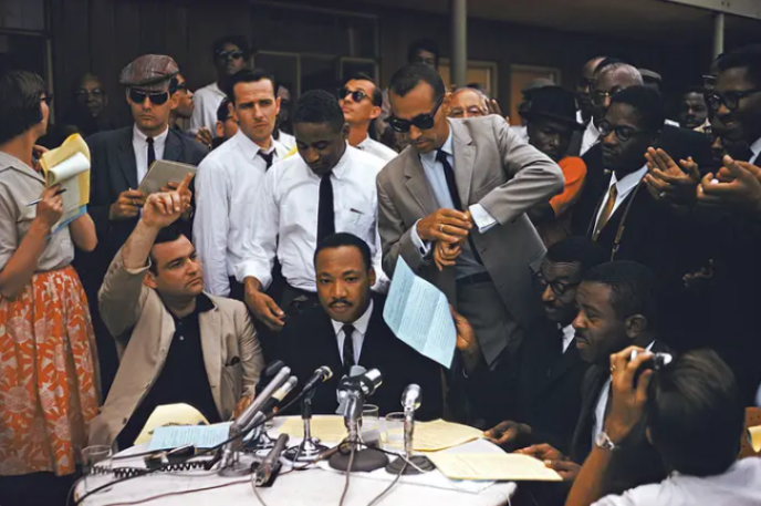 Photo of Martin Luther King, Jr.  surrounded by media in 1962. Photo courtesy of Getty Images/Ernst Haas.