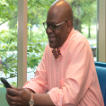 Man reading on his mobile device at Charlotte Mecklenburg Library.