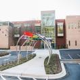 A front-entrance view of the newly renovated South County Regional Library branch with public art titled "Open Book, Open Mind" by Jim Gallucci.